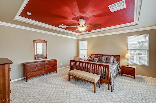 bedroom featuring carpet, visible vents, and a tray ceiling