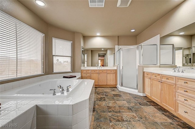 full bathroom featuring a whirlpool tub, a stall shower, a sink, and visible vents