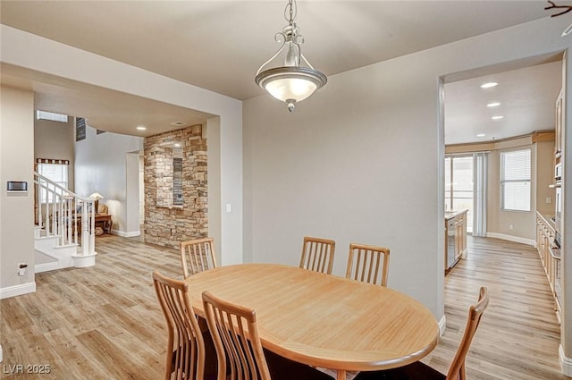 dining room featuring stairs, recessed lighting, baseboards, and light wood-style floors