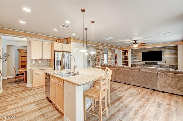 kitchen featuring light brown cabinetry, appliances with stainless steel finishes, and visible vents