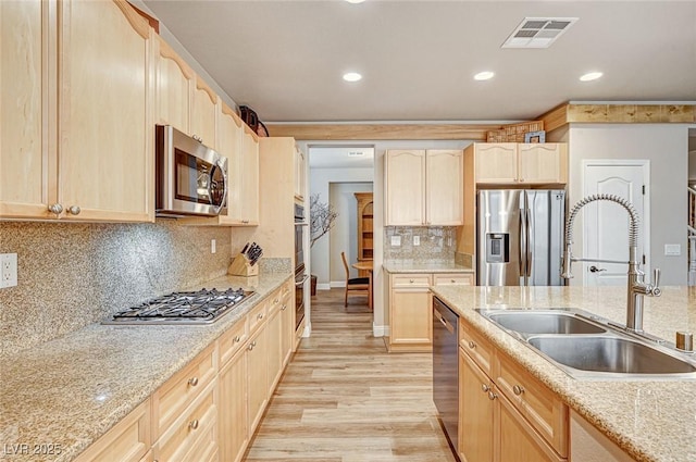 kitchen with visible vents, stainless steel appliances, and light brown cabinetry