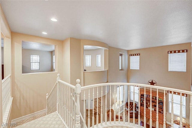 hallway with recessed lighting, an upstairs landing, and baseboards