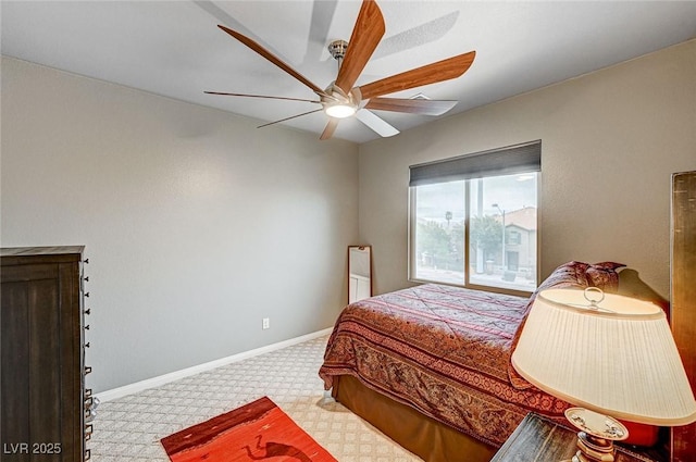 bedroom with a ceiling fan and baseboards