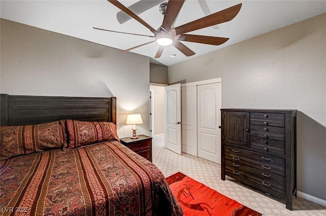 bedroom featuring a ceiling fan, a closet, and baseboards