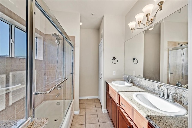 3550 Bay Sands Dr Unit 2087, Laughlin, NV 89029 - bathroom with double vanity, tile patterned flooring, a chandelier, baseboards, and tiled shower / bath