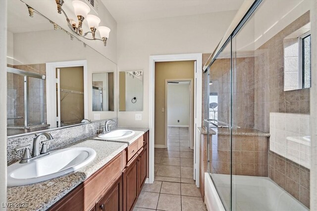 3550 Bay Sands Dr Unit 2087, Laughlin, NV 89029 - full bath with tile patterned floors, double vanity, shower / bath combination with glass door, a chandelier, and baseboards