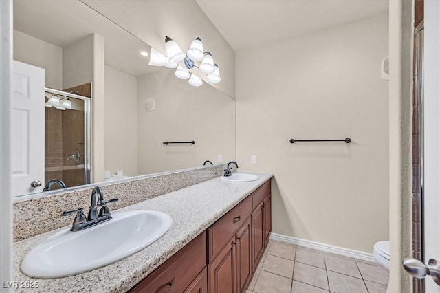 3550 Bay Sands Dr Unit 2087, Laughlin, NV 89029 - bathroom featuring toilet, tile patterned flooring, baseboards, double vanity, and a stall shower