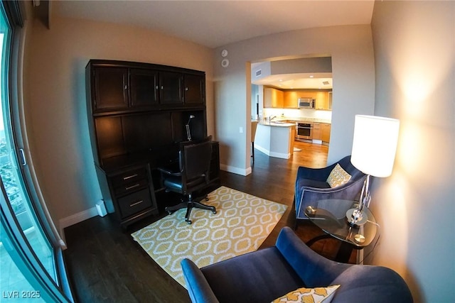 office area featuring dark wood-style floors and baseboards