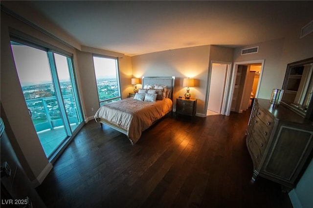 bedroom with baseboards, visible vents, and dark wood-style flooring