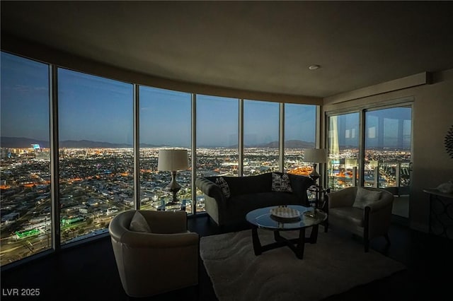 living area featuring a view of city and floor to ceiling windows