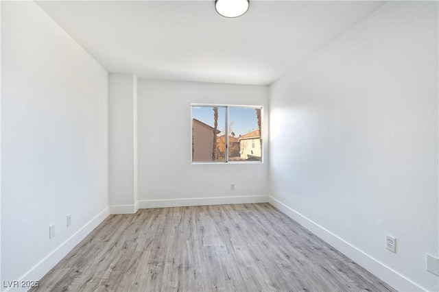 unfurnished room featuring wood finished floors and baseboards