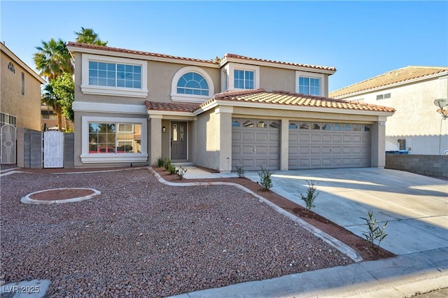 mediterranean / spanish-style home featuring a tile roof, stucco siding, a gate, a garage, and driveway