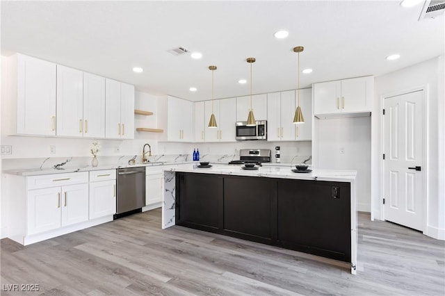 kitchen with open shelves, appliances with stainless steel finishes, visible vents, and white cabinetry