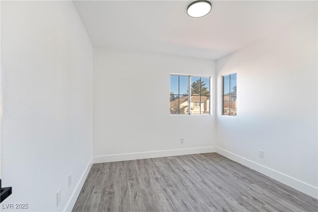 empty room featuring baseboards and wood finished floors