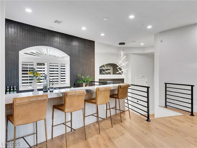 kitchen with light wood finished floors, visible vents, and recessed lighting