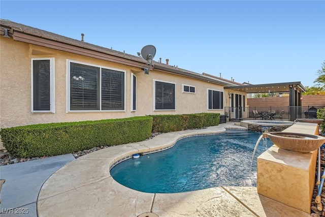 view of swimming pool with a patio area, fence, a fenced in pool, and an in ground hot tub