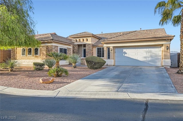 view of front of property featuring a garage, stone siding, driveway, and stucco siding