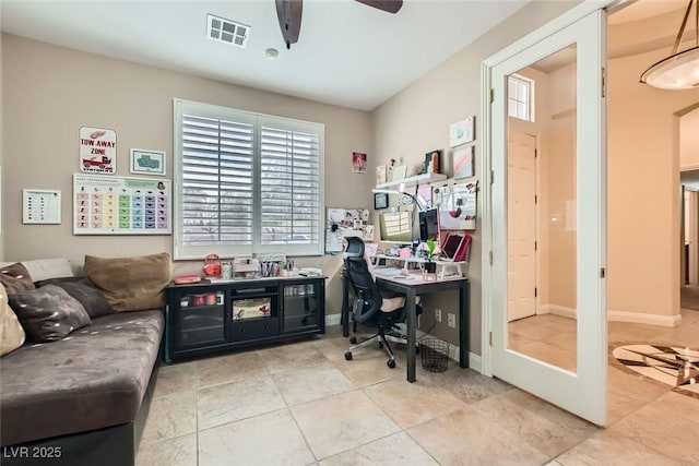 tiled office space featuring a ceiling fan, visible vents, and baseboards