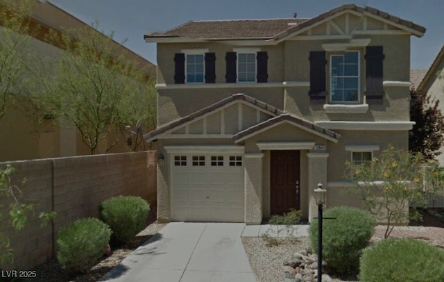 craftsman-style home with a garage, fence, concrete driveway, and stucco siding