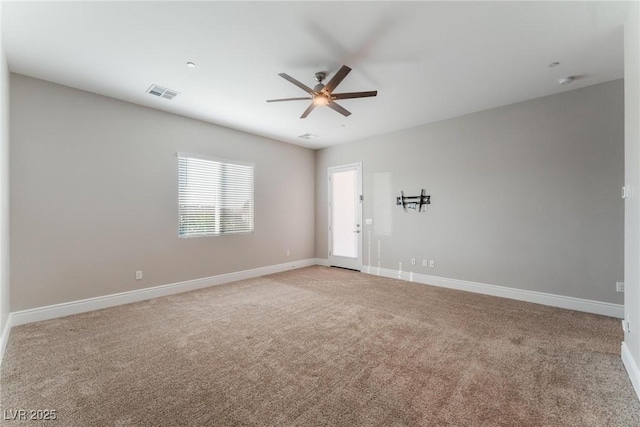 empty room featuring light carpet, baseboards, visible vents, and a ceiling fan