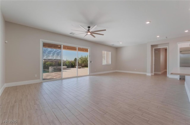 empty room with light wood finished floors, baseboards, a ceiling fan, and recessed lighting