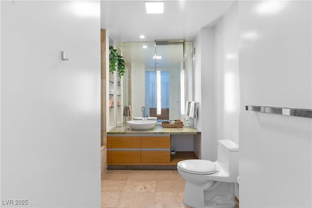 bathroom featuring toilet and vanity