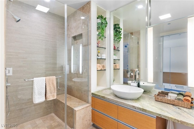 bathroom featuring a shower stall and vanity