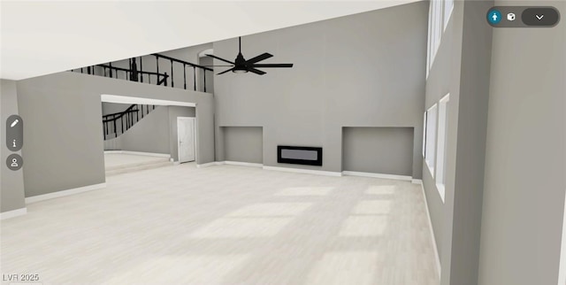 unfurnished living room with a high ceiling, baseboards, a fireplace, and stairway