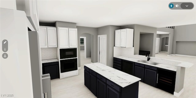 kitchen with a center island, wall oven, a sink, black microwave, and dark cabinetry