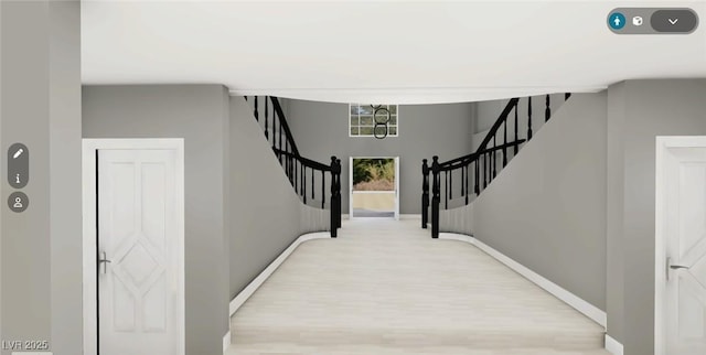 interior space featuring stairway, baseboards, and light wood finished floors