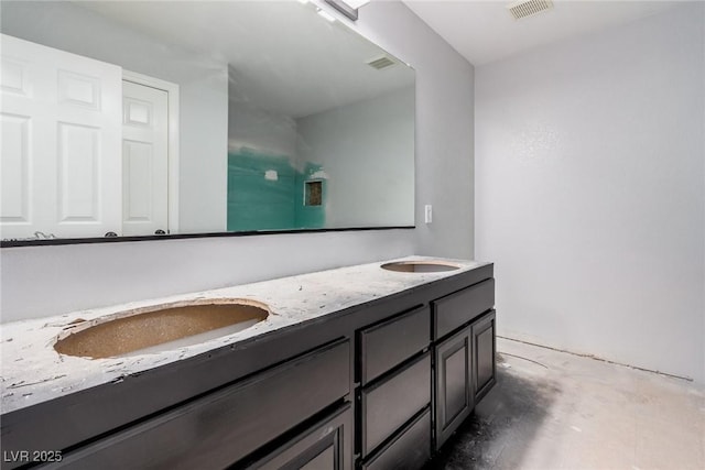 full bath featuring double vanity, visible vents, and a sink