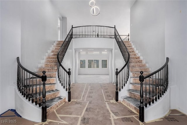 stairway with a towering ceiling