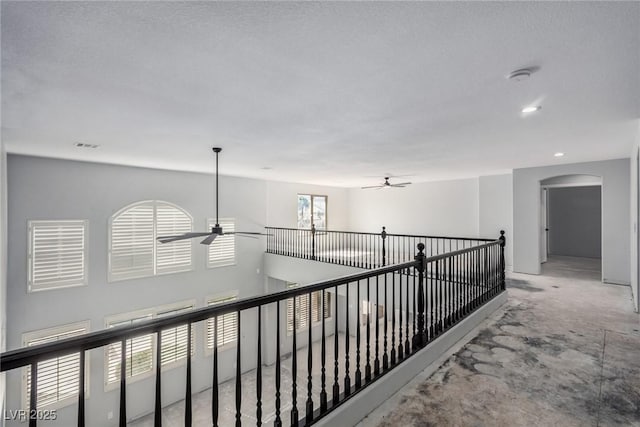 hallway with arched walkways and visible vents