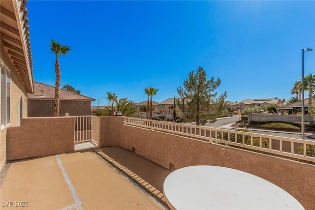 view of patio featuring a residential view and a balcony