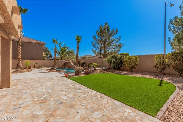 view of yard featuring a patio area and a fenced backyard