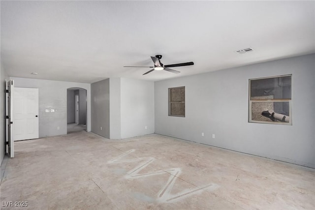 spare room with arched walkways, ceiling fan, and visible vents