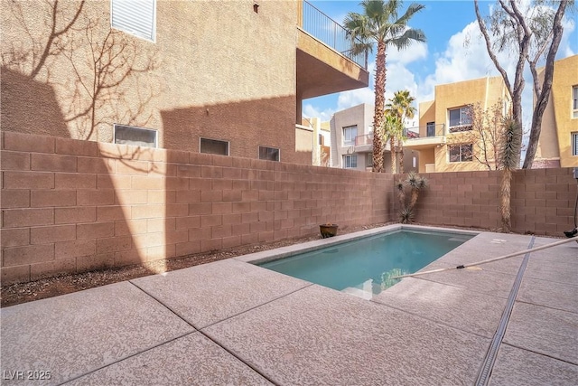 view of pool featuring a patio area and a fenced backyard