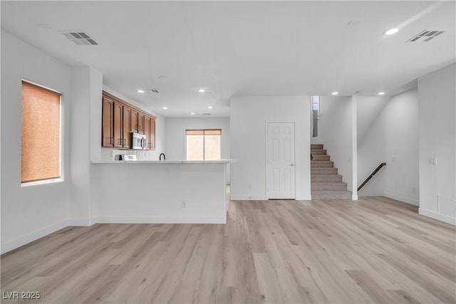 unfurnished living room featuring recessed lighting, visible vents, and light wood finished floors