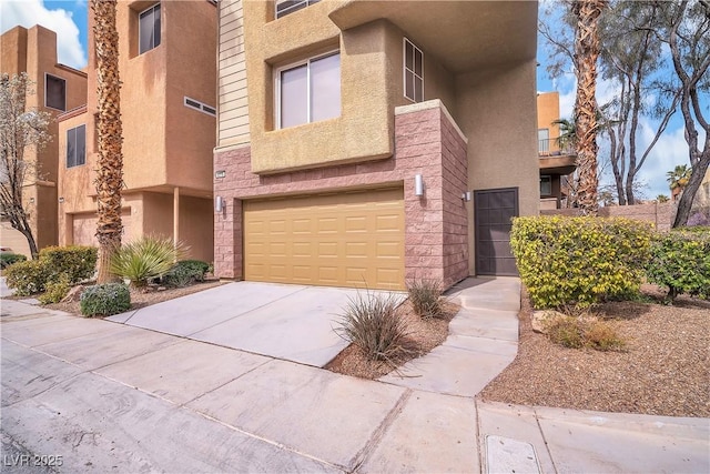 view of front of house featuring a garage, driveway, and stucco siding