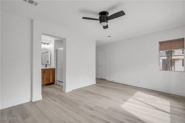 unfurnished bedroom featuring light wood-style floors, baseboards, and visible vents