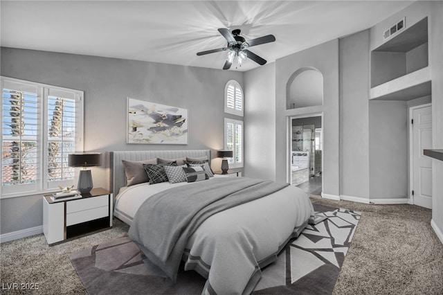 bedroom featuring baseboards, visible vents, a towering ceiling, ceiling fan, and carpet