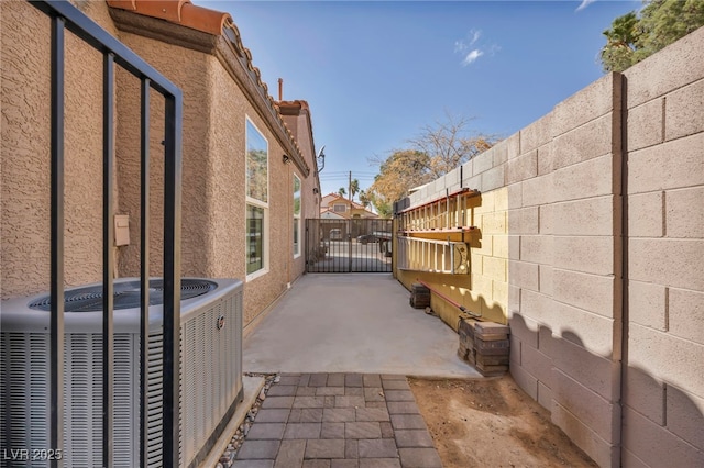 exterior space with central AC unit and fence