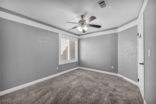 empty room with a ceiling fan, carpet, a textured wall, and baseboards