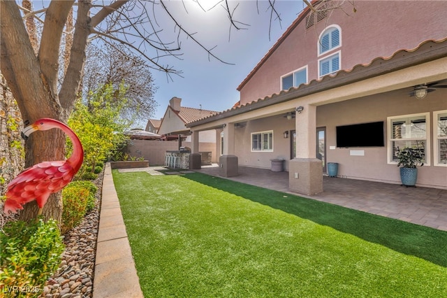 view of yard with ceiling fan, a patio, and fence