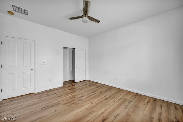 unfurnished bedroom with light wood-style flooring, baseboards, visible vents, and a closet