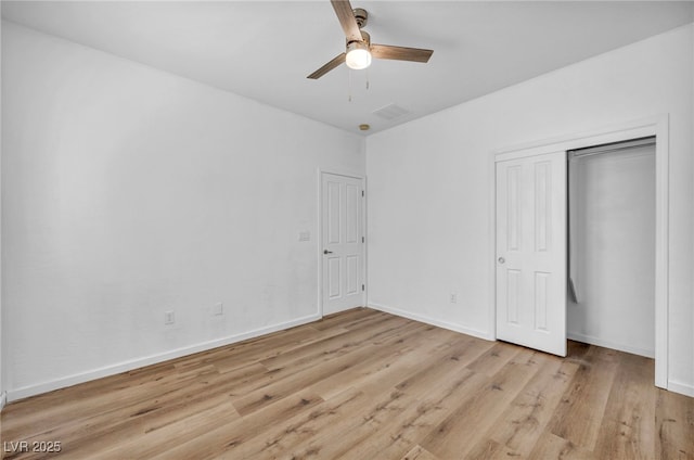 unfurnished bedroom with a ceiling fan, baseboards, visible vents, a closet, and light wood-type flooring