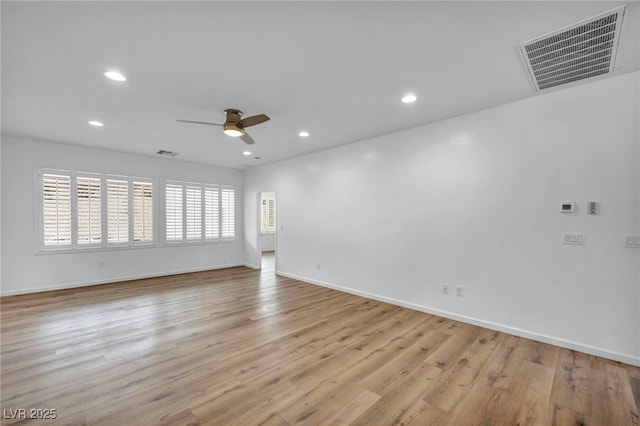 empty room with light wood finished floors, visible vents, recessed lighting, and baseboards