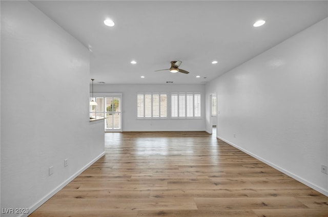 interior space with recessed lighting, baseboards, light wood-style floors, and a ceiling fan