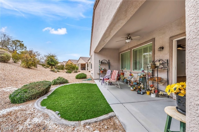 view of yard with a ceiling fan and a patio area