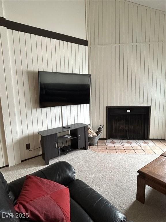 living room with wood walls and a fireplace